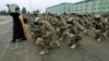 A priest blesses Georgian soldiers during a farewell ceremony at the Vaziani military base outside Tbilisi in December, before the troops' departure to Afghanistan.