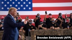 U.S. President Donald Trump gestures as he arrives for a rally at Yuma International Airport on August 18 in Yuma, Arizona.