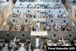 Medical workers and patients are seen in the treatment hall of a temporary hospital for coronavirus patients in the Krylatskoye Ice Palace in Moscow on November 18.