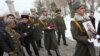 Armenia - An honor guard holds the picture of Sergeant Armen Hovannisian during his state funeral in Yerevan's Yerablur military cemetery, 22Jan2014.