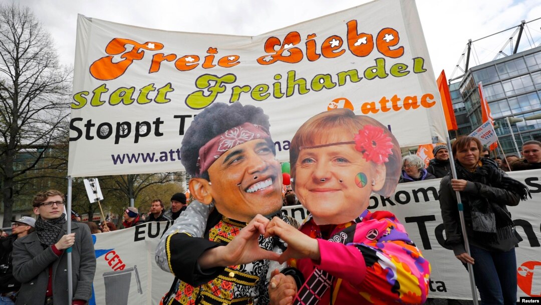 Protesters wearing masks depicting German Chancellor Angela Merkel and U.S. President Barack Obama demonstrate against Transatlantic Trade and Investment Partnership (TTIP) agreement ahead of Obama's visit to Hannover on April 23.