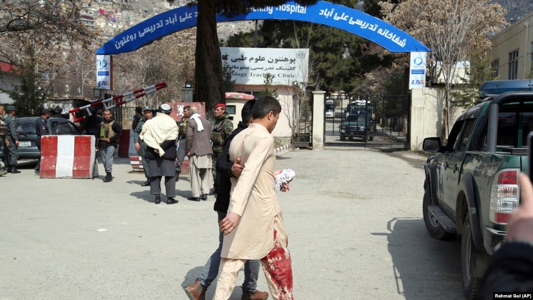 An injured man is taken to a hospital following a number of deadly blasts in the Afghan capital, Kabul, on March 21. 