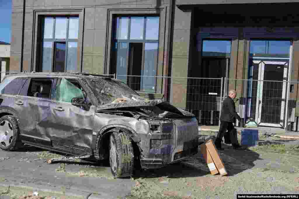 A damaged luxury vehicle at a car dealership in Kyiv following the strikes