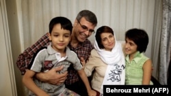 Lawyer Nasrin Sotoudeh poses with her husband, Reza Khandan, her son Nima (L) and her Daughter Mehraveh (R ) at her house in Tehran, September 18, 2013