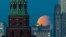 Russia - Partial lunar eclipse is seen over the Kremlin and Russia's Foreign Ministry headquarters building in Moscow, September 18, 2024. 