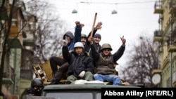 Jubilant Euromaidan activists patrol the center of Kyiv after the departure of ousted Ukrainian President Viktor Yanukovych on the weekend. 