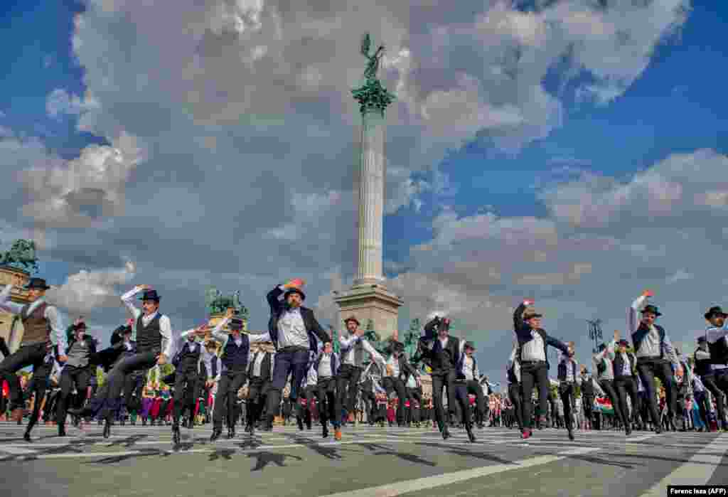 Hungarian folk dancers take part in a World War II memorial event on Heroes Square in Budapest on June 4. (AFP/Ferenc Isza)