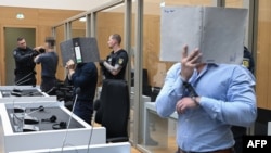 Троє обвинувачених у суді в день винесення вироку, 18 серпня 2026 року