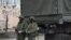 Armed men who are believed to be Russian troops on the streets of Simferopol.