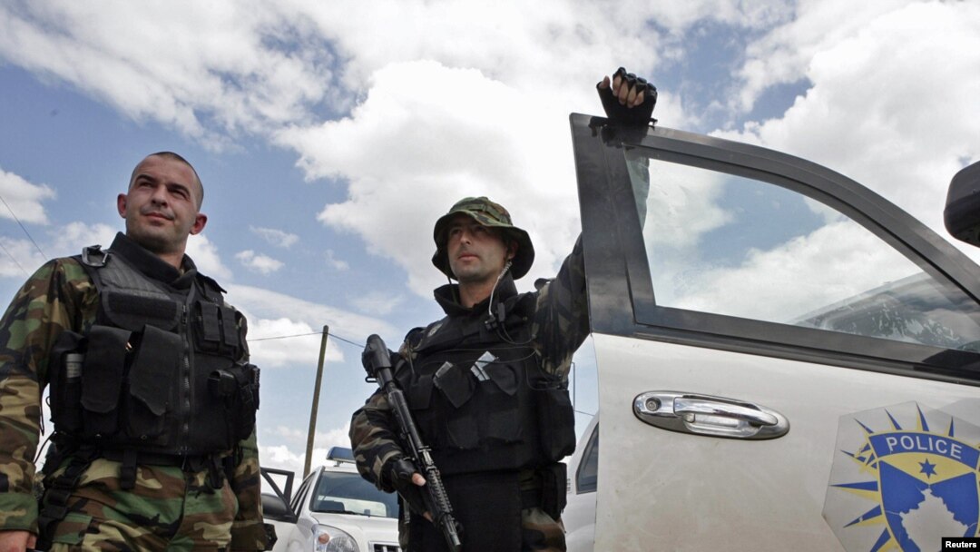 Members of the Kosovar special police forces stand by their vehicle in the ethnically divided town of Mitrovica on July 26. 