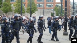 Riot police patrol after trouble on Market street in Manchester city center on August 9.