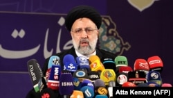 Iranian judiciary chief Ebrahim Raisi speaks to reporters after registering his candidacy for Iran's presidential election at the Interior Ministry in Tehran on May 15.