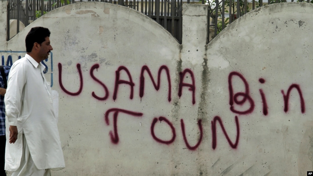 A man walks past graffiti reading "Usama Bin Town" in Abbottabad on May 6.