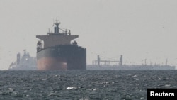 Cargo ships sail in the Gulf near the Strait of Hormuz (file photo)