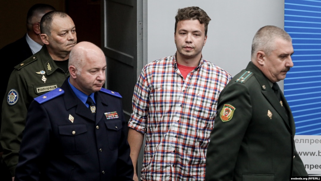 Belarus - Chief of the Air Force and Air Defense Command of the Armed Forces of Belarus Igor Golub (L), Belarusian activist Roman Protasevich (C) and Chairman of the Investigative Committee of Belarus Dmitry Gora (R) enter the press center before a briefi
