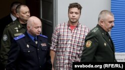 Belarus - Chief of the Air Force and Air Defense Command of the Armed Forces of Belarus Igor Golub (L), Belarusian activist Roman Protasevich (C) and Chairman of the Investigative Committee of Belarus Dmitry Gora (R) enter the press center before a briefi