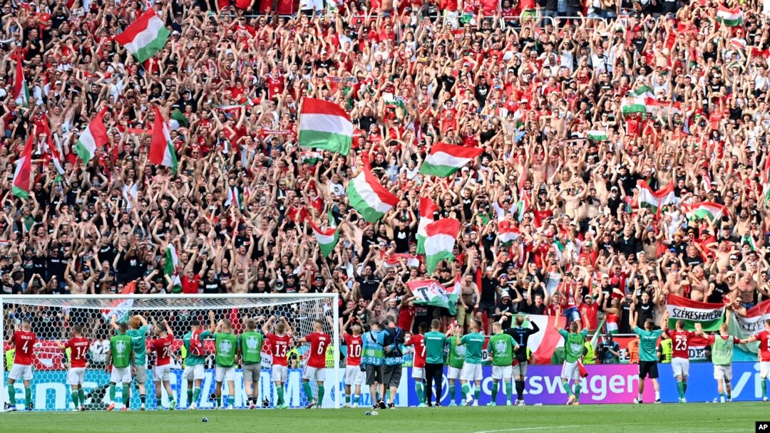 Hungary's players celebrate with fans after the Euro championship Group F match with France at Ferenc Puskas stadium in Budapest on June 19. 