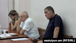 Armenia - Police officer Aram Navasardian (right) stands trial in Yerevan, July 29, 2025.