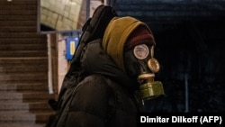 A man wearing a gas mask waits on the platform at the Biblioteka Imeni Lenina subway station in Moscow.