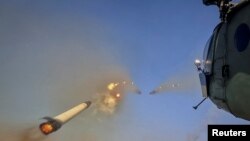 A Ukrainian military Mi-8 helicopter fires unguided missiles toward Russian troops in an undisclosed location in eastern Ukraine on September 29.