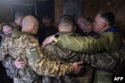 Ukrainian soldiers pray during a religious service in a makeshift church at an undisclosed location near Slovyansk, Donetsk region, on April 10.