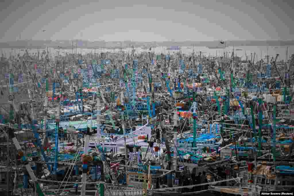 A view of anchored fishing boats after Pakistani fishermen in Karachi were advised not to venture out to sea due to rough conditions following the cyclonic storm Gulab in the Arabian Sea.