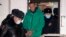 Aleksei Navalny is escorted out of a police station on January 18 in Khimki, outside Moscow.