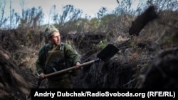 A Ukrainian soldier digs a trench near the front line in the eastern Donetsk region in September.