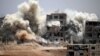 Smoke rises around buildings following a strike on a rebel-held Daraa in June. A Cease-fire is to take effect July 9.