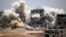 Smoke rises around buildings following a strike on a rebel-held Daraa in June. A cease-fire is due to take effect July 9.