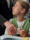 Confused Caucasian little girl child school kid pupil student schoolgirl playing mobile phone online game during lesson woman female strict teacher professor take away smartphone play inside classroom