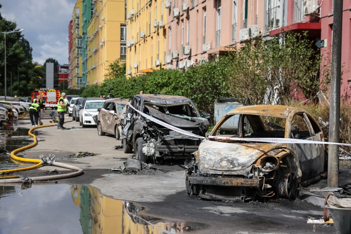 Розташований поруч із школою житловий будинок також зазнав пошкоджень. Припарковані автівки згоріли внаслідок російського удару. Київ, 15 червня 2026 року
