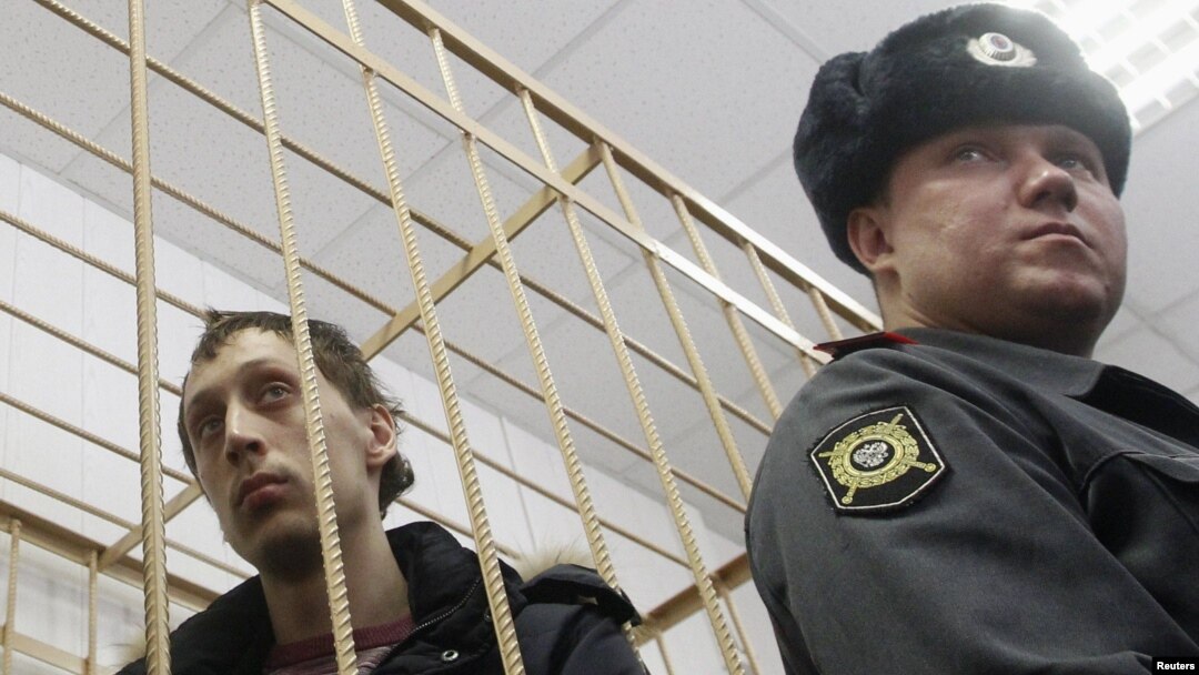 Bolshoi dancer Pavel Dmitrichenko (left) in the dock during a court hearing in Moscow on March 7