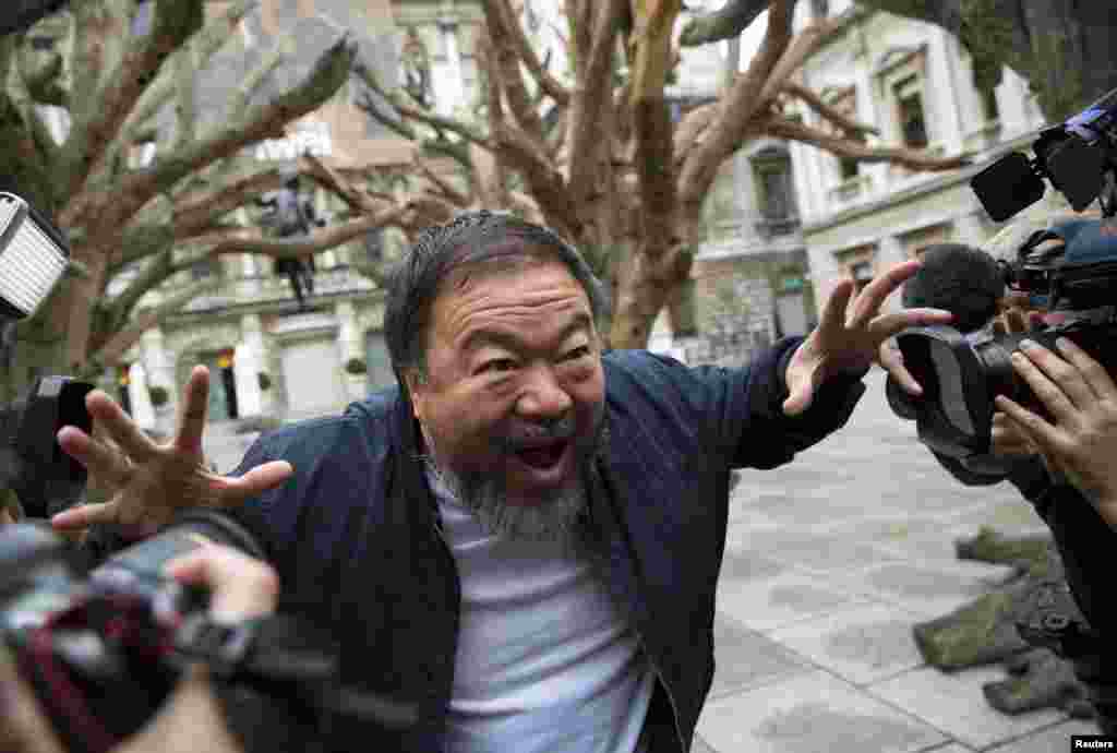 Chinese artist Ai Weiwei poses for photographers during a photocall for his exhibition at the Royal Academy of Arts in London. (Reuters/Neil Hall)