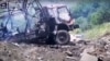 A video grab appearing to show the charred remains of the vehicle. 