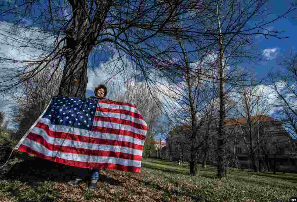 &nbsp;A supporter holding a U.S. flag waits for the &quot;Dragoon Ride&quot; U.S. Army convoy to arrive at a Czech Army barracks in Prague on March 30. (epa/Filip Singer)