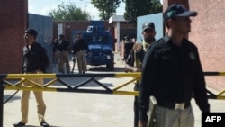 A Pakistani anti-terrorism court official arrives in an armored vehicle at Adyala Prison in Rawalpindi