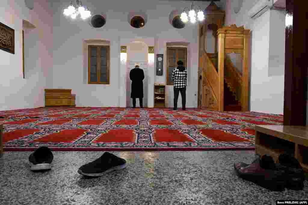 An imam and a worshipper pray alone in a mosque in Podgorica, Montenegro, on April 23. The first night of the holy month of Ramadan came amid a government-imposed nationwide lockdown to prevent the spread of the coronavirus.