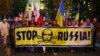 Poland -- People hold a banner with the words 'Stop Russia' during a march, commemorating the 75th anniversary of the Soviet Union's invasion of the eastern part of Poland at the outbreak of World War II, in front of Russian embassy in Warsaw, September 1