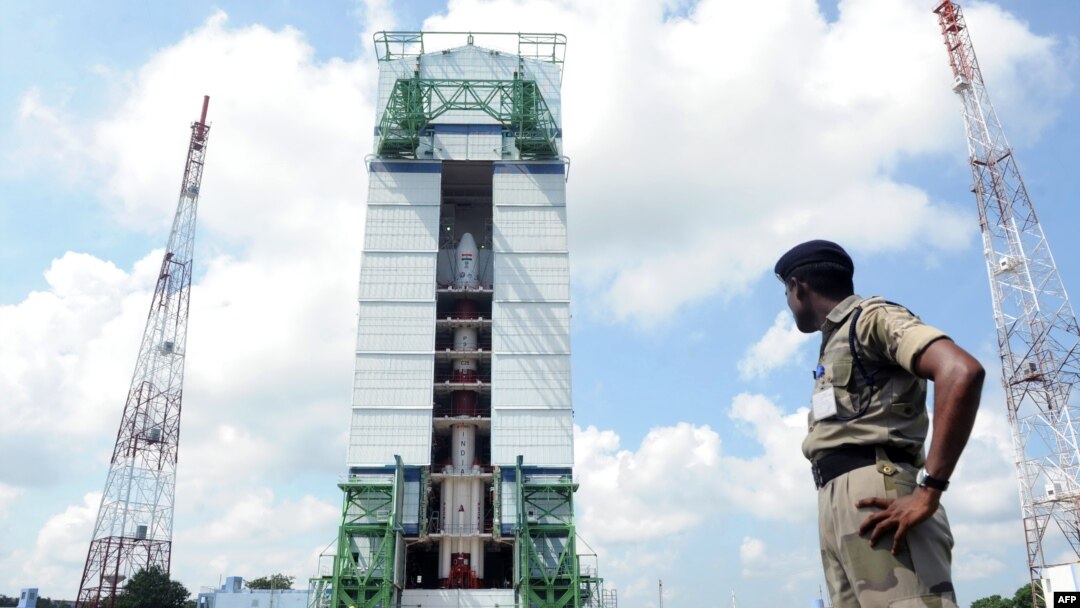 An Indian security troop patrols near the PSLV-C25 launch vehicle, carrying the Mars Orbiter probe as its payload, at the Indian Space Research Organization facility in Sriharikota on October 30.