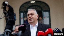 Hungarian Prime Minister Viktor Orban gives a statement to the press after casting his vote in Budapest on April 3.