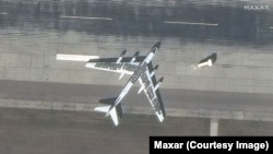 A Russian strategic bomber aircraft is seen covered in tires at the Engels-2 Air Base near Saratov in 2023.