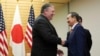 U.S. Secretary of State Mike Pompeo, left, and Japan's Chief Cabinet Secretary Yoshihide Suga shake hands at Prime Minister's office in Tokyo Saturday, Oct. 6, 2018. Pompeo has arrived in Tokyo for talks with Japanese officials ahead of his trip to North 