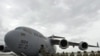 U.S. soldiers board a plane bound for Afghanistan at the U.S. Transit Center at Manas airport.