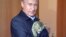 Russian President Vladimir Putin and a feline friend