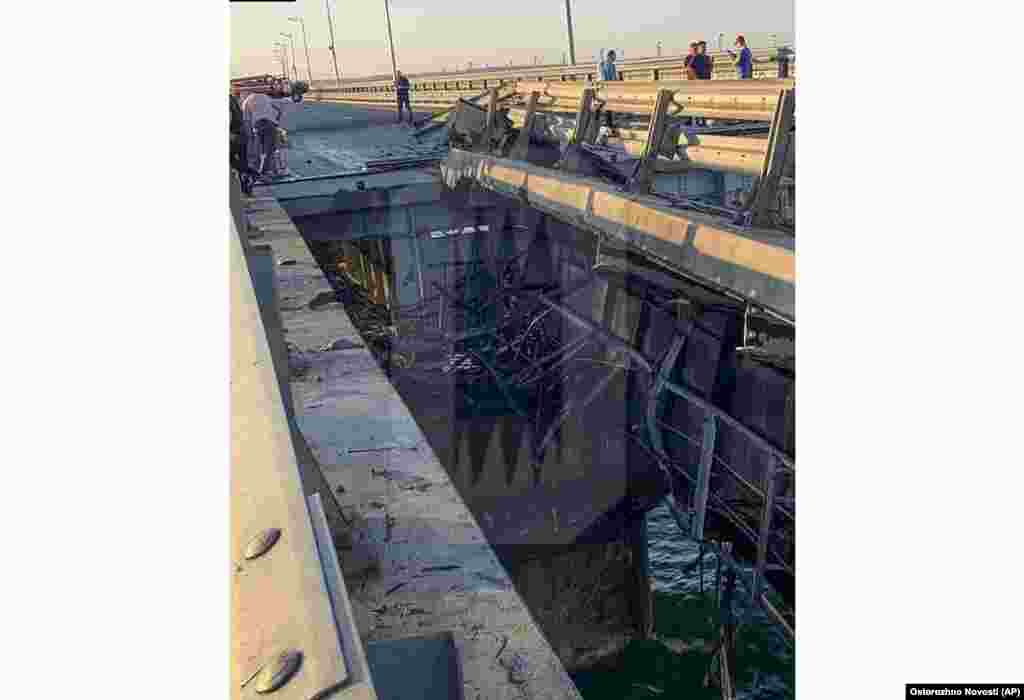 This photo released by Ostorozhno Novosti on Monday, July 17, 2023, reportedly shows damaged parts of an automobile link of the Crimean Bridge connecting Russian mainland and Crimean peninsula over the Kerch Strait not far from Kerch, Crimea. Traffic on the key bridge connecting Crimea to Russia&#39;s mainland was halted on Monday, July 17, after reports of explosions that Crimean officials said were from a Ukrainian attack.(Ostorozhno Novosti via AP)