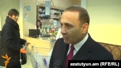 Armenia - Prime Minister Hovik Abrahamian talks to the press at a Yerevan supermarket, 18Dec2014.