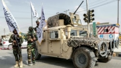 Taliban officers patrol a street during a rally marking the fourth anniversary of the militants' takeover of Afghanistan, in Ghazni on August 15, 2025.