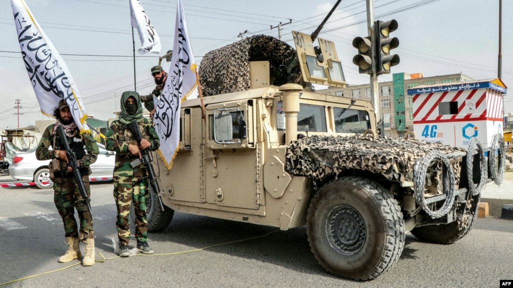 Taliban fighters pose in Ghazni on August 15, the fourth anniversary of the group seizing power in Afghanistan. 
