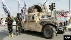 Taliban fighters pose in Ghazni on August 15, the fourth anniversary of the group seizing power in Afghanistan.